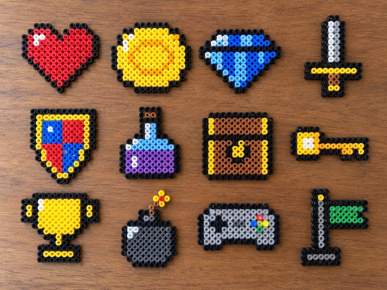 Video Game Loot — Finished bead projects on a wooden tabletop
